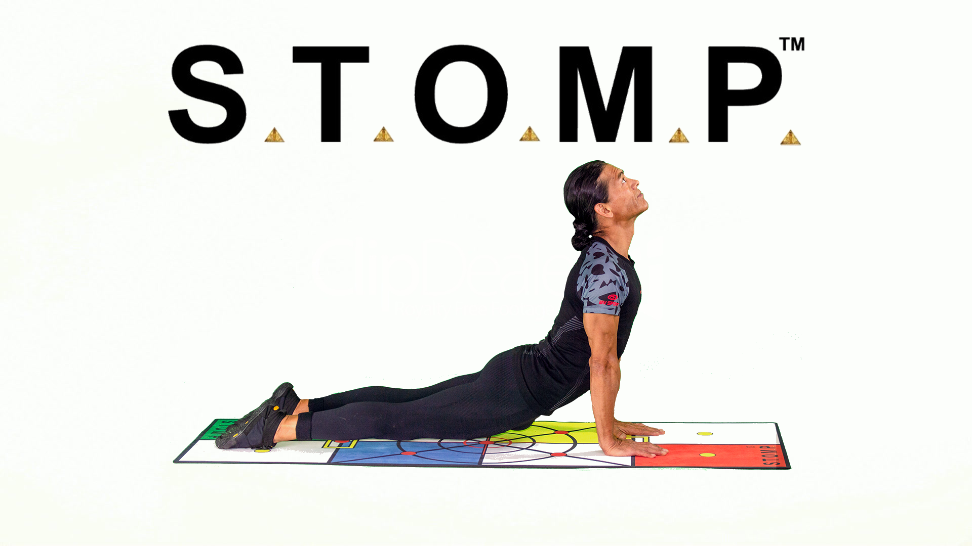 Daniel performing yoga on the STOMP Mat